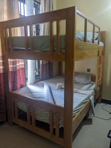 two bunk beds in a room with a window at Mashingo Homestay in Dar es Salaam
