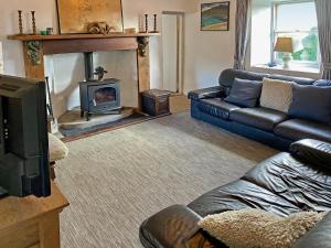 a living room with a couch and a fireplace at 4 Bed in Ballyconneely oc-i236 in Callow