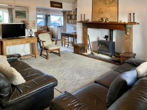 a living room with a couch and a fireplace at 4 Bed in Ballyconneely oc-i236 in Callow