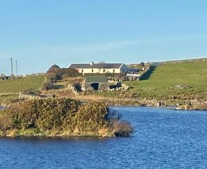 a house on an island in a body of water at 4 Bed in Ballyconneely oc-i236 in Callow +14 photos