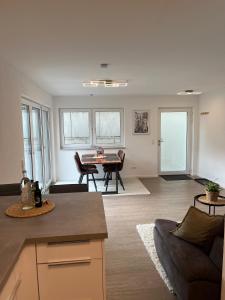 a living room with a couch and a table at Helles & modernes Apartment mit privater Terrasse in Schwäbisch Hall