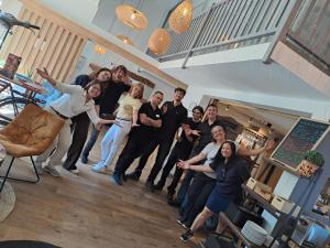 a group of people posing for a picture in a living room at Sure Hotel by Best Western Angers Sud in Les Ponts-de-Cé