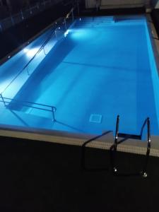 a swimming pool with blue lights on it at Apartamentos Florida Gran Canaria Adults Only in Puerto Rico de Gran Canaria +13 photos
