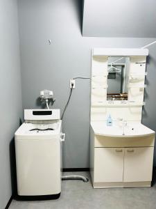 a bathroom with a sink and a mirror at 宿中村屋 in Aomori +16 photos