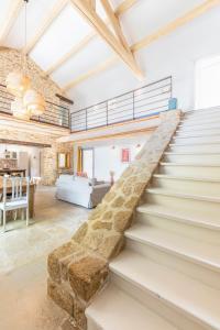 a staircase in a house with a living room at La Bastide du Père Mathieu Jacuzzi couvert et Piscine in Suze-la-Rousse