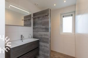 a bathroom with a sink and a shower at Gezellige vakantiewonig gelegen in Grijpskerke in Grijpskerke +32 photos