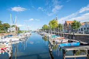 a group of boats are docked in a marina at Gezellige vakantiewonig gelegen in Grijpskerke in Grijpskerke