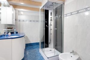 a bathroom with a shower and a toilet and a sink at Apartment Goldener Schnee Tesero in Tesero +15 photos