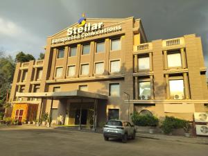 a building with a car parked in front of it at Stellar Resorts By Bel-La Monde, Rajokri, Near IGI Airport, Delhi in New Delhi