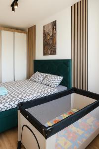 a bedroom with two beds and a green headboard at RIVER LuX in Veliko Gradište +28 photos