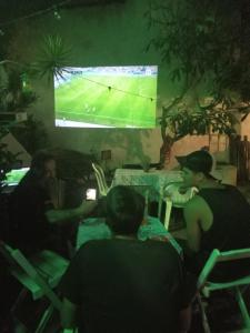 a group of people sitting in chairs watching a soccer game at Ganesha do mar in Búzios +25 photos