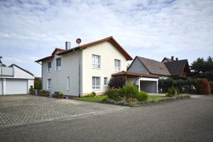 a white house with a brown roof at Ferienhaus Elsa 180 qm in Rust