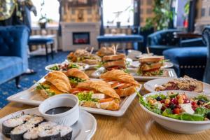 a table with several plates of food on it at Hotel Tommy Wellness & Spa in Náchod