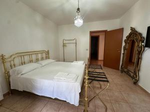 a bedroom with a white bed and a mirror at Bari Double Sea View in Bari