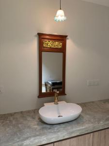 a bathroom sink with a mirror on a counter at LM Motel in Kulim +18 photos