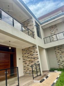 a modern home with a staircase and a house at Kigali Garden in Kigali