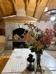 un vaso di fiori su un tavolo con camino di Evina kuća a Vrzići