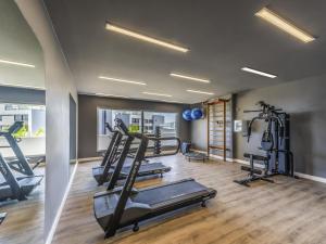 a gym with treadmills and ellipticals in a room at Novotel Salvador Rio Vermelho in Salvador