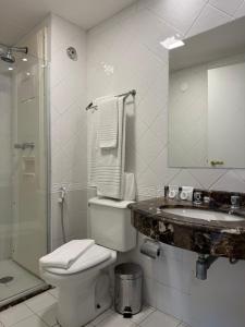 a bathroom with a toilet and a sink and a shower at Dream Flat Pinheiros in Sao Paulo
