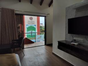 a living room with a flat screen tv on a wall at Mudra Resort in Nagaon