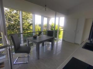 a dining room with a table and chairs on a balcony at Alleeblick in Fürth