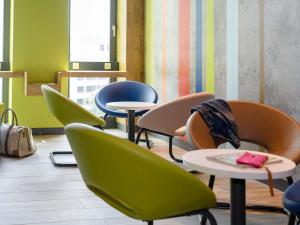 a group of chairs and tables in a room at ibis budget Bremen City Center in Bremen +44 photos