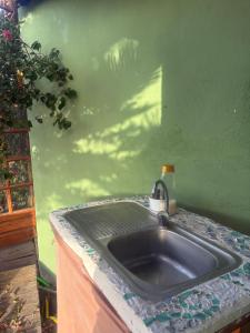 a sink in a room with a green wall at The Good Vibes Home in Hoya de Pineda