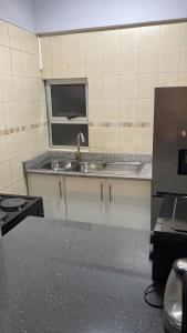 a kitchen with a sink and a window at Akwabahouse in Durban