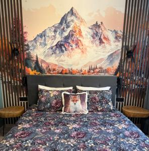 a dog sitting on a bed in front of a mountain mural at FOX boutique apartment Borovets Gardens in Borovets