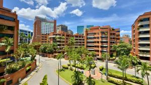 a city street with palm trees and buildings at Apartment in Campo Alegre Chacao - Privileged Location in Caracas