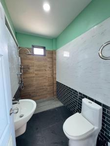 a bathroom with a toilet and a sink at Nabua Thalenoi Resort in Ban Thale Noi
