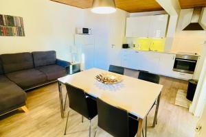 a kitchen and living room with a table and a couch at Cozy Apartment next to the Slopes Sleeps 4 in Vars