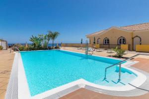 a large swimming pool in front of a building at Ocean Pearl Loma Verde in Patalavaca