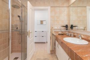 a bathroom with a sink and a shower at Ocean Pearl Loma Verde in Patalavaca +41 photos