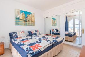 a bedroom with two beds and a balcony at Ocean Pearl Loma Verde in Patalavaca