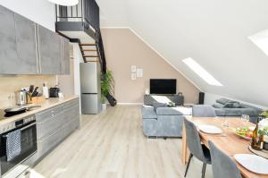 a kitchen and living room with a couch and a table at AT Weinmeister - außergewöhnlich & groß in Bielefeld +13 photos