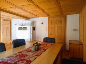 a dining room with a wooden table and chairs at Haus Kanisfluh in Au im Bregenzerwald