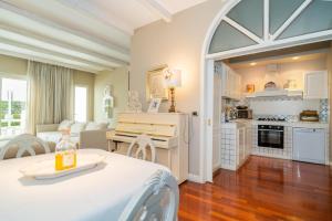 a living room with a table and a kitchen at ComeCasa La Finestra sul Mare Apartment in Aci Castello