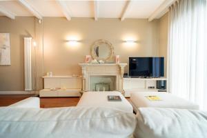 a living room with two beds and a fireplace at ComeCasa La Finestra sul Mare Apartment in Aci Castello