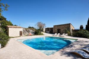 a swimming pool in front of a house at Le Fort de Bramafan in Caumont-sur-Durance