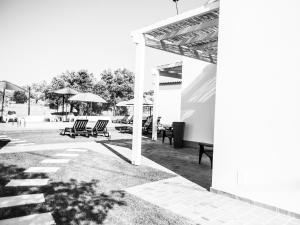 a group of chairs and umbrellas on a patio at Tavira Monte in Tavira
