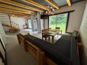 a room with a table and a bench in a house at Відпочинковий комплекс Біла Кобила in Verkhovyna +29 photos
