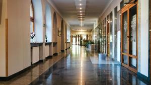 a hallway of a building with a tile floor at Ośrodek Wypoczynkowo-Dydaktyczno-Konferencyjny in Zakopane