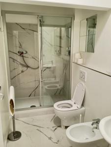 a white bathroom with a toilet and a shower at MassMart 1 in Servigliano