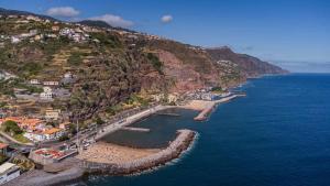 an aerial view of a town on a mountain at SeaSalt Whisper - Guest House in Calheta