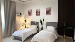 Ένα ή περισσότερα κρεβάτια σε δωμάτιο στο استديو بوصول ذاتي غرفتين