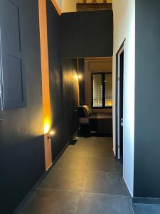 a hallway with a room with a table and a chair at UNIQUE Apartments with rooftop & Netflix in Faenza