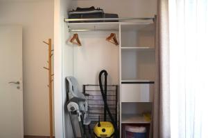 a closet with a glass door with tools in it at Le Jardin de Sauge in Le Teich