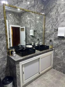 a bathroom with two sinks and a large mirror at Meknès 2 Perle de Meknes in Meknès