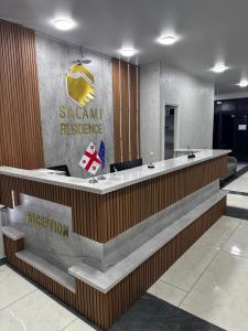 a salamiami restaurant with a reception desk in a lobby at New Batumi City Center in Kakhaberi
